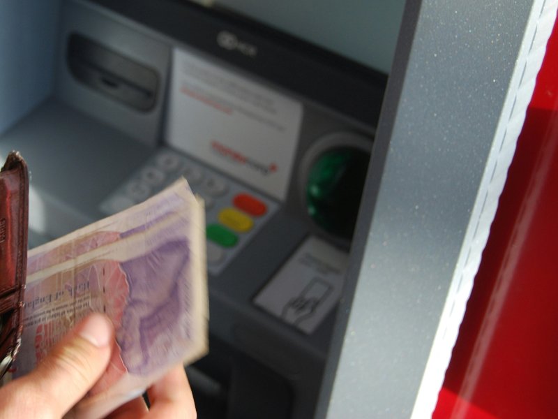 A person withdrawing money from UK ATM