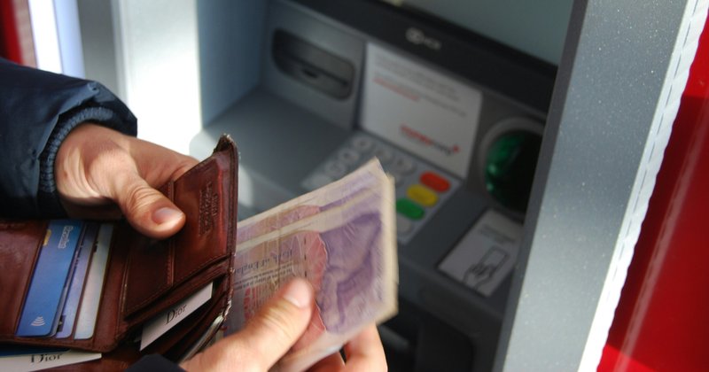 A person withdrawing money from UK ATM