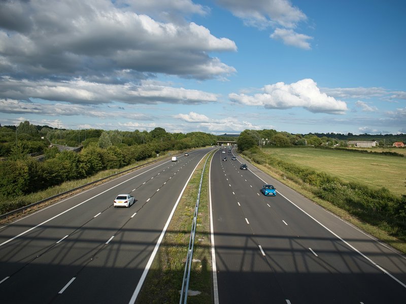 An image of a road with cars on it.