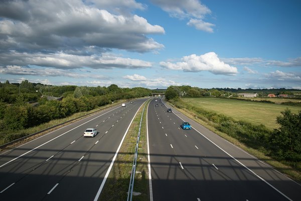 An image of a road with cars on it.