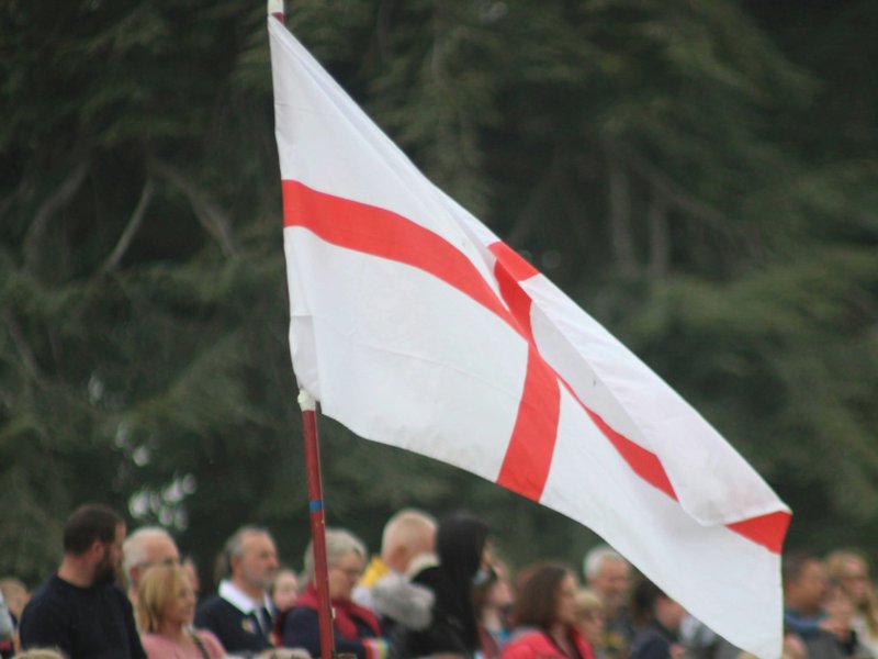 A group of people with the St George’s flag.