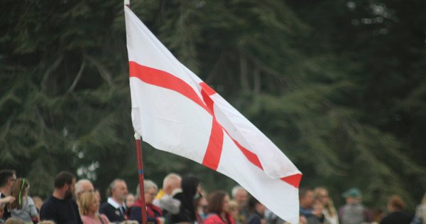 A group of people with the St George’s flag.