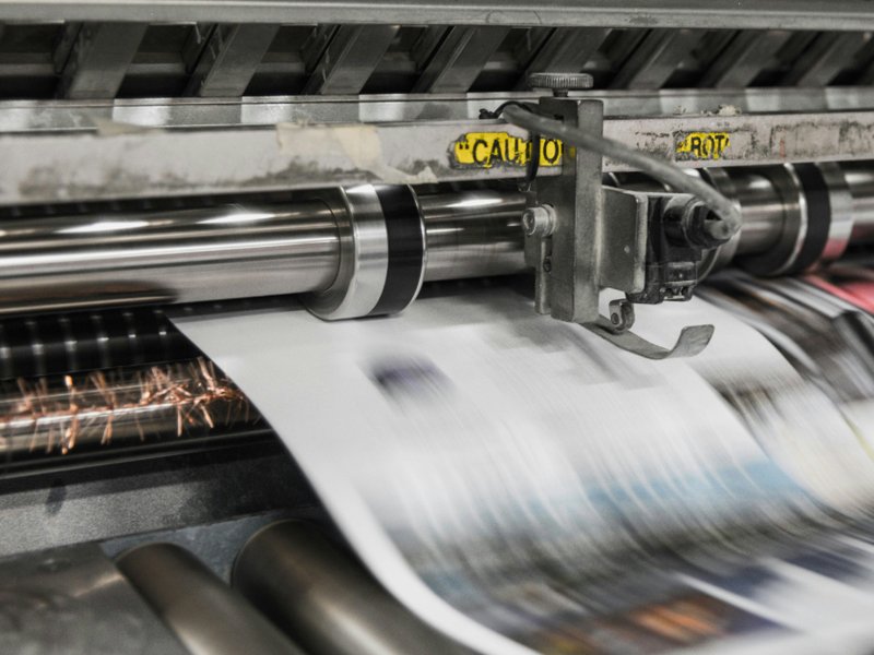 An image of newspapers being printed