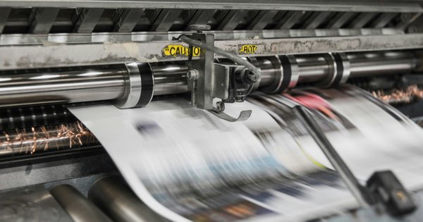 An image of newspapers being printed