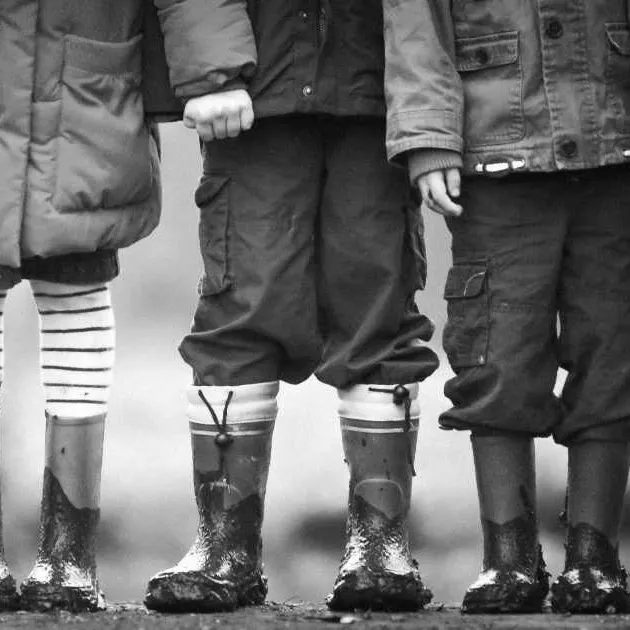 A photo of children playing in the mud.