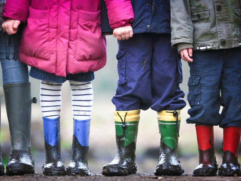 A photo of children playing in the mud.