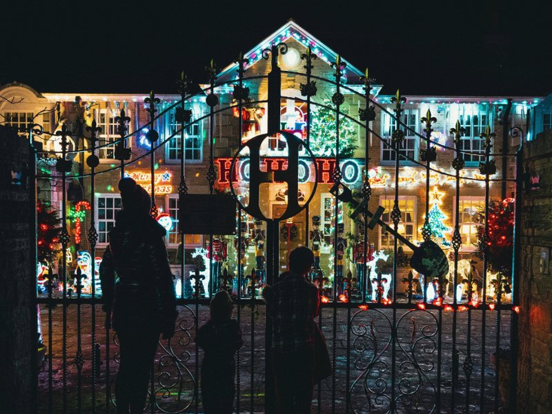 A picture of a family visiting Christmas lights on a house in Sheffield, UK