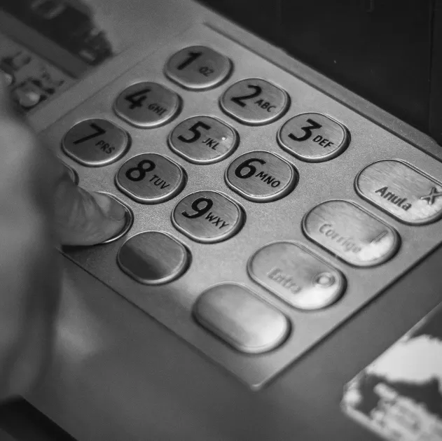 Person pressing keys of an ATM