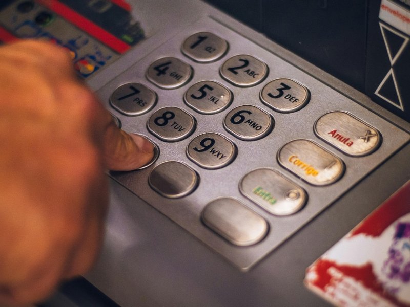 Person pressing keys of an ATM