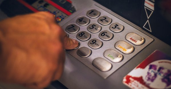 Person pressing keys of an ATM