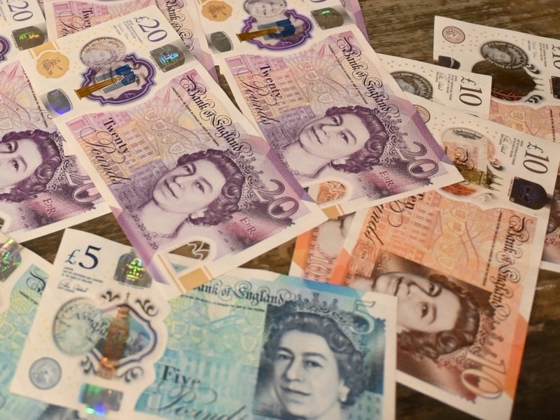 Cash notes strewn across a table