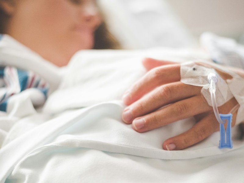 A woman lying in a hospital bed