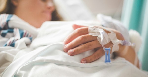A woman lying in a hospital bed