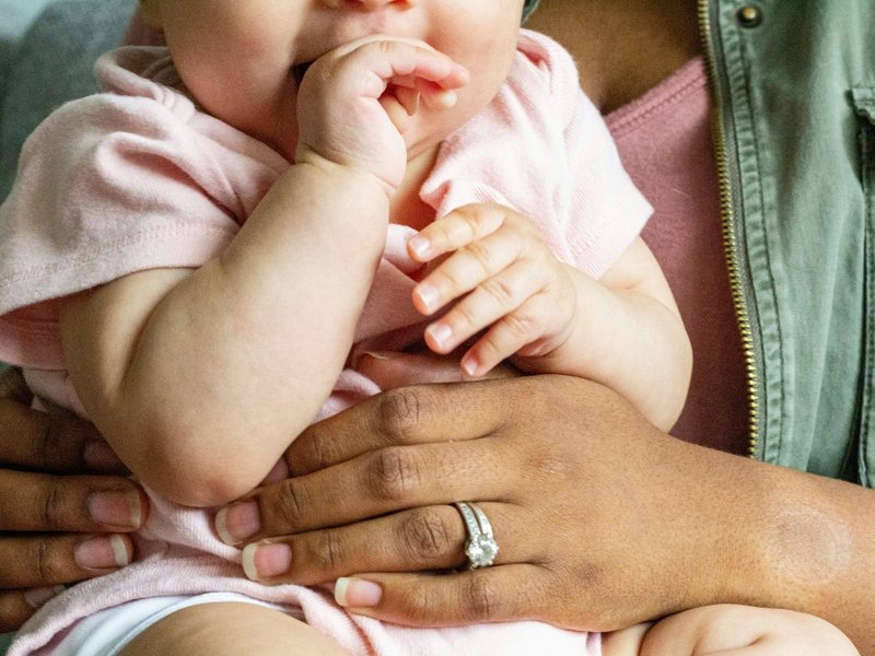 Baby being held by adult