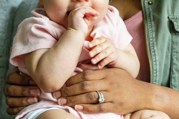 Baby being held by adult