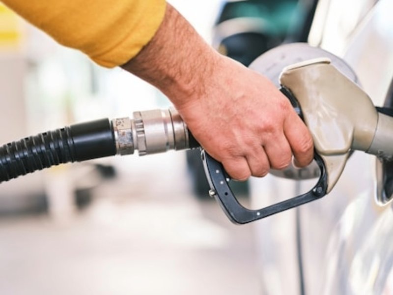 An image of a man refuelling a car.