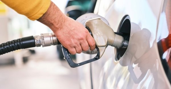An image of a man refuelling a car.