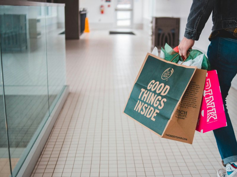 Person walking with shopping bags.