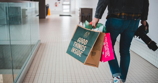 Person walking with shopping bags.