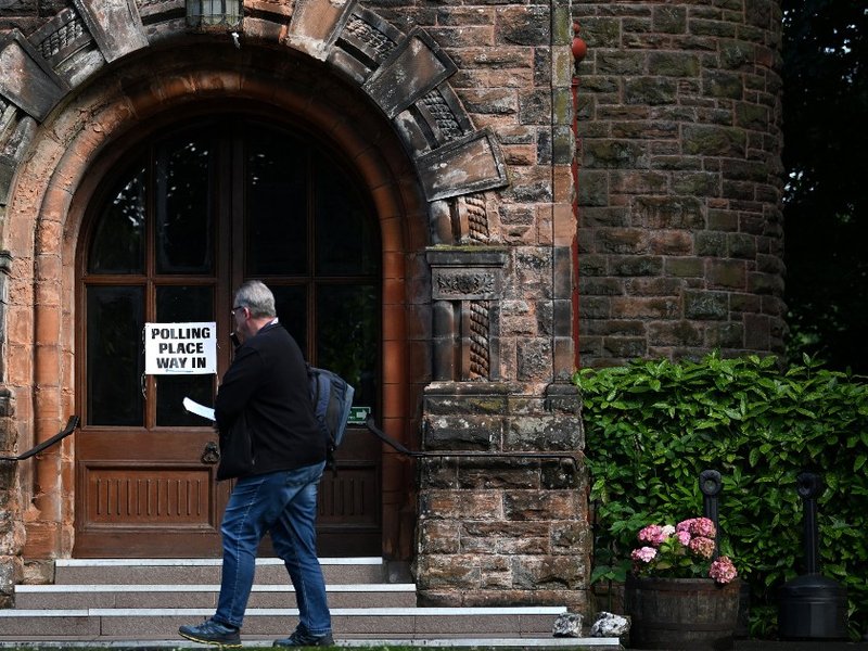 A person walking into a polling station in Glasgow, Scotland