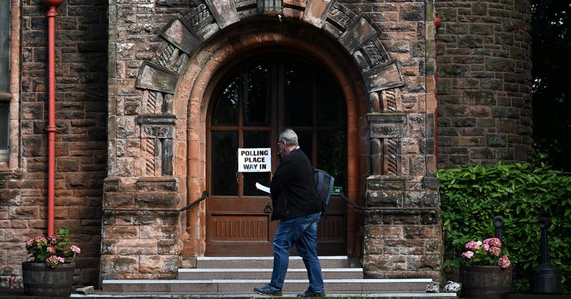 A person walking into a polling station in Glasgow, Scotland
