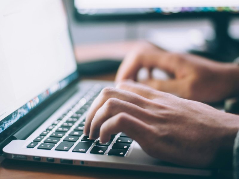 A picture of someone using a laptop