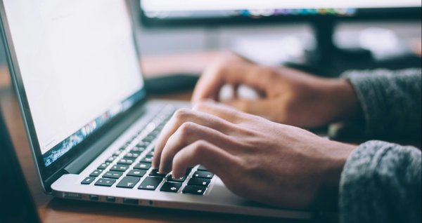 A picture of someone using a laptop