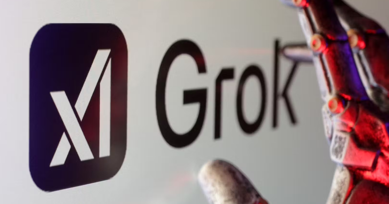 An image of the Grok AI logo with a robot hand in the foreground.