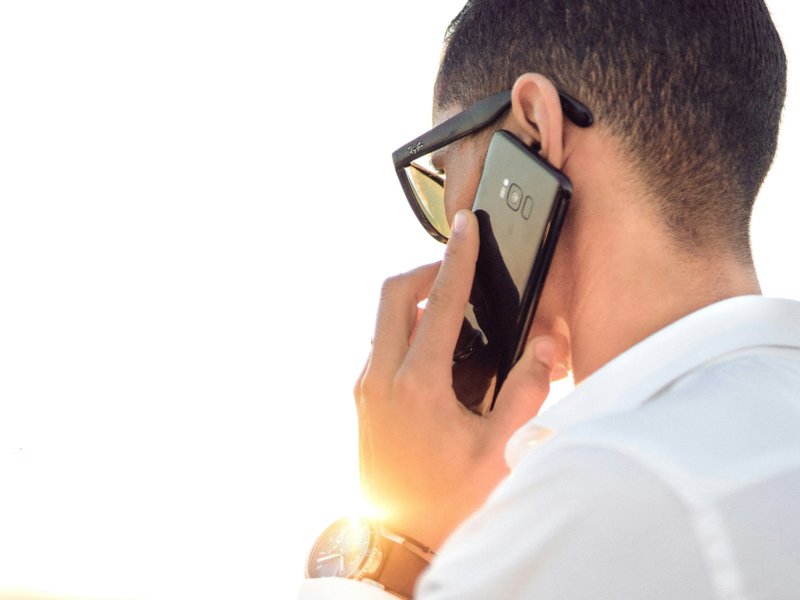 Man holding a mobile phone to his ear.