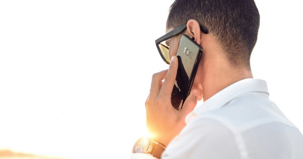 Man holding a mobile phone to his ear.