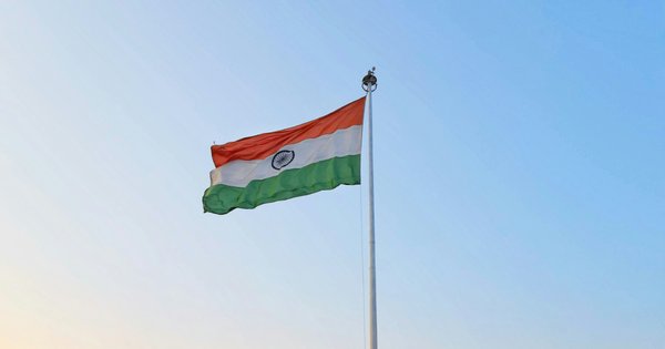 The Indian national flag flying on a flagpole.