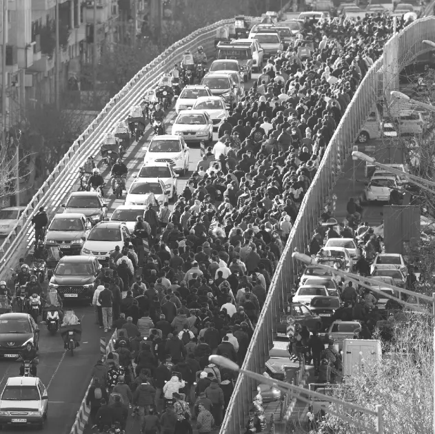 Shopkeepers and traders walk over a bridge during a protest against the economic conditions and Iran's embattled currency in Tehran on December 29.