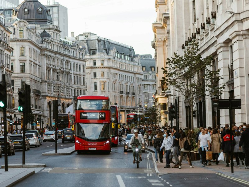 A view of a bus driving down a street in central London.