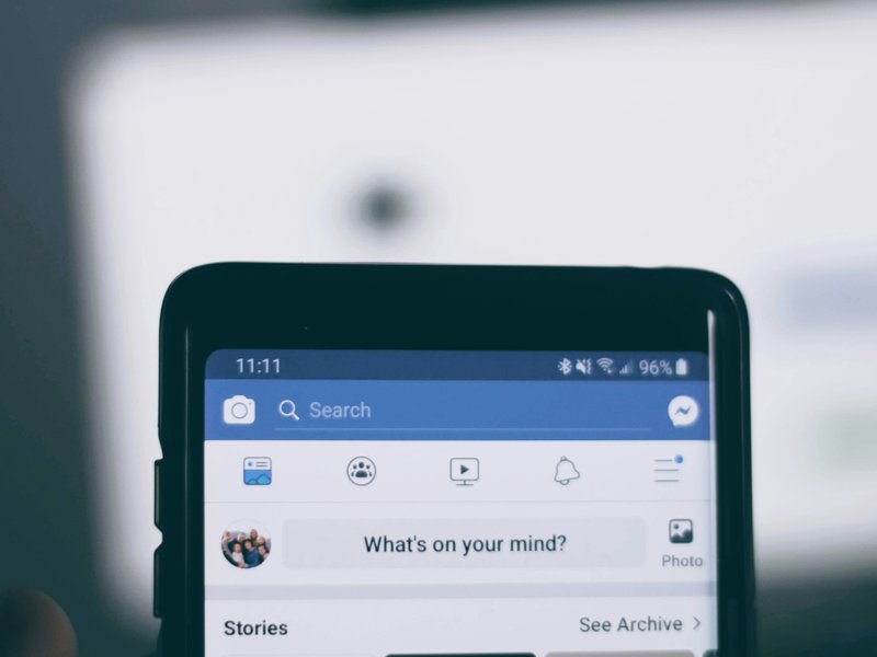 A phone showing the Facebook homepage