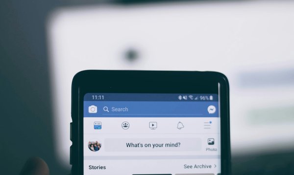 A phone showing the Facebook homepage