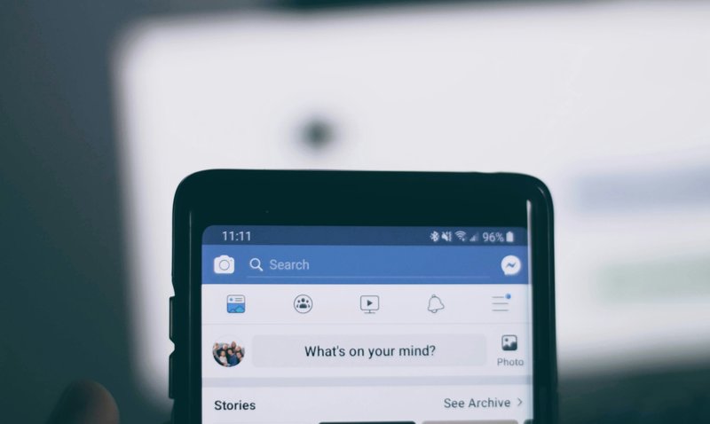 A phone showing the Facebook homepage