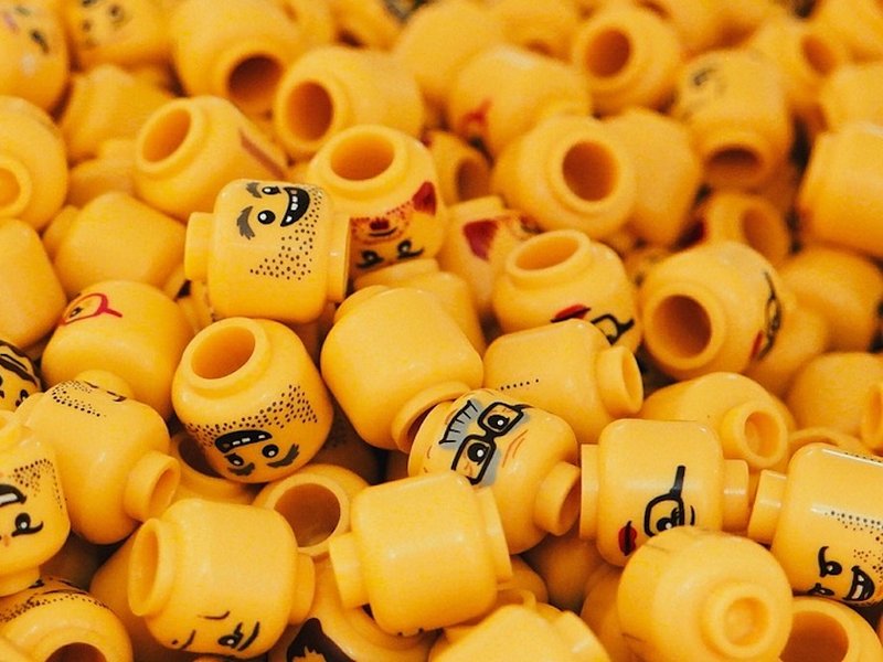 An assortment of Lego figurine heads in a pile