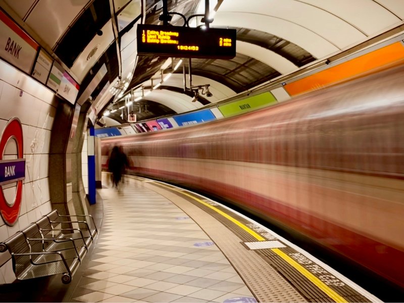 A picture of a Tube train travelling through Bank London Underground station.