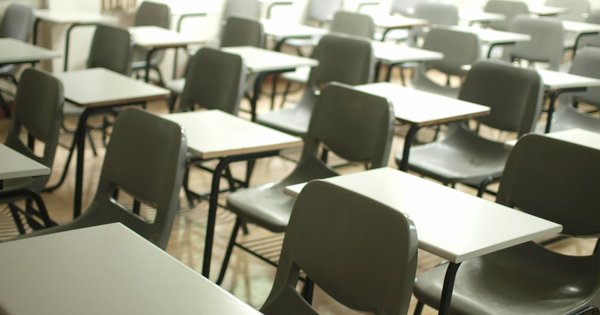 A picture of tables and chairs in a classroom.