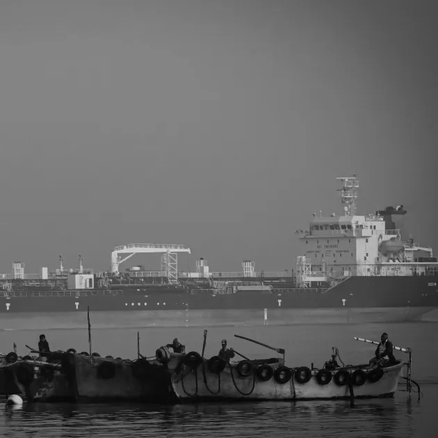 Wooden boats and cargo ship off the coast of Chittagong, Bangladesh