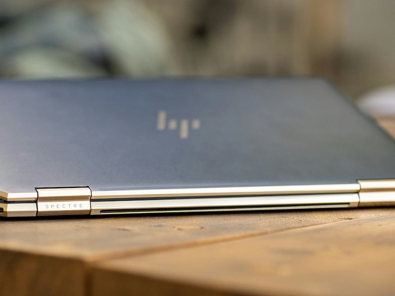 Silver laptop on brown wooden table