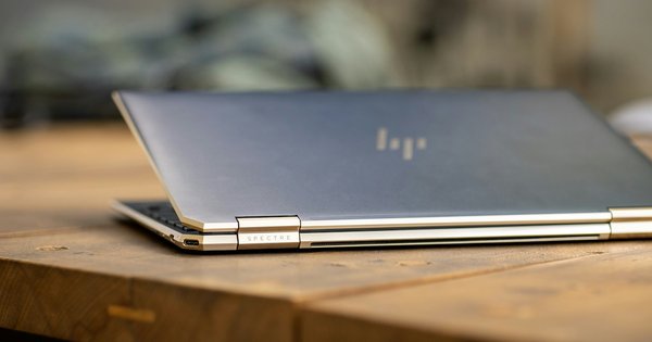 Silver laptop on brown wooden table