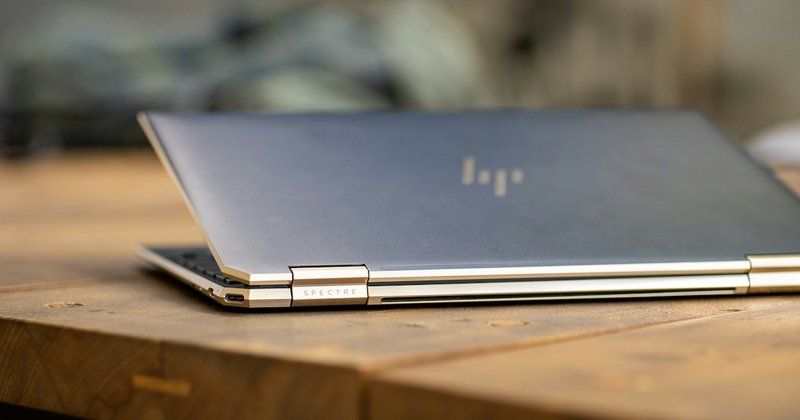 Silver laptop on brown wooden table