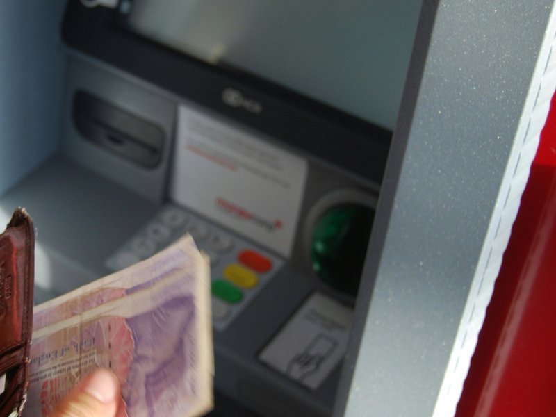 Person withdrawing money from UK ATM