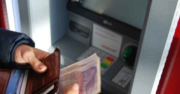 Person withdrawing money from UK ATM