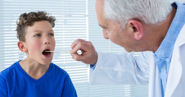 pikwizard-doctor-examining-patients-mouth.jpg