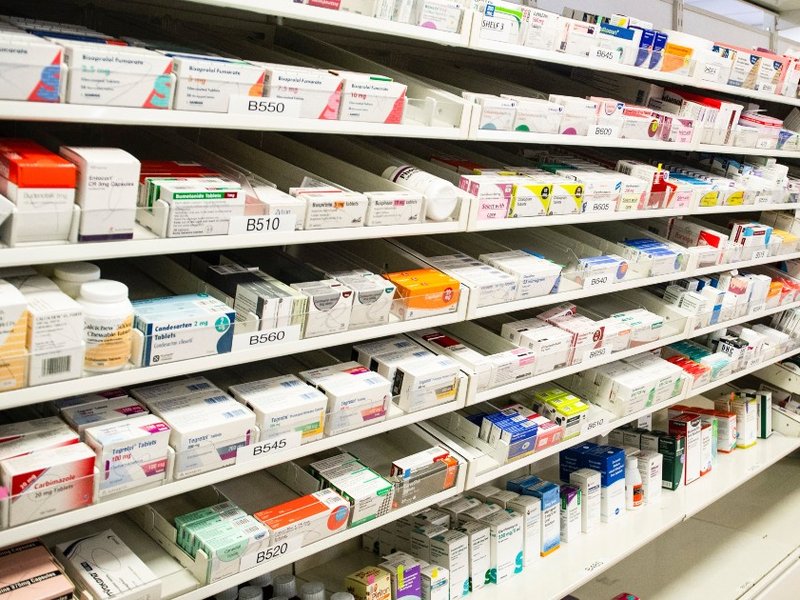 Medications on shelves in a pharmacy.