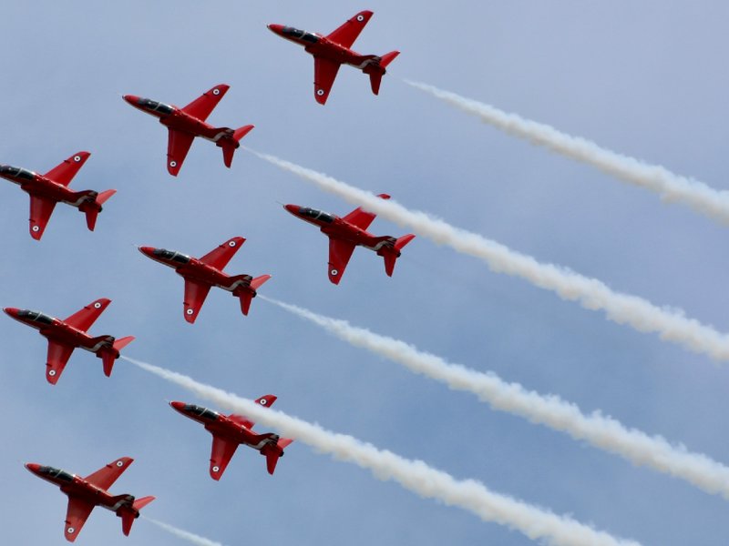 The Red Arrows using white smoke in the sky.
