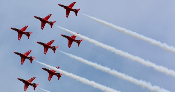 The Red Arrows using white smoke in the sky.