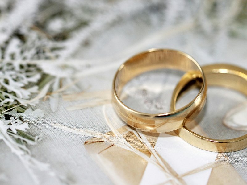Two gold rings on a white background
